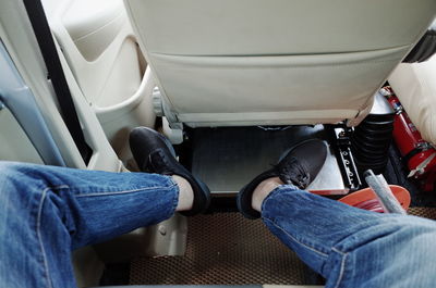 Low section of person sitting in airplane