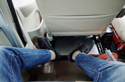 Low section of person sitting in airplane