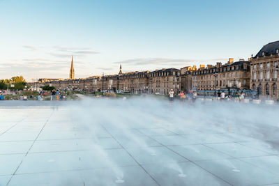 People walking in city at sunset