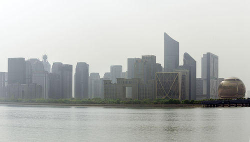 Modern buildings in city against clear sky