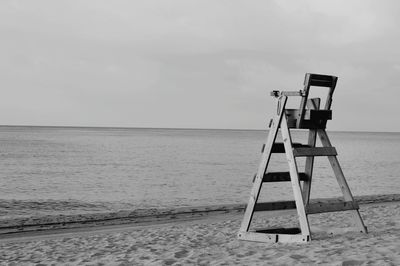 Lifeguard hut on beach against sky