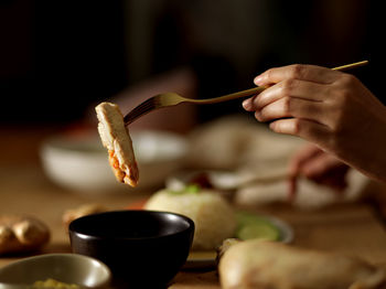 Close-up of person holding food on table