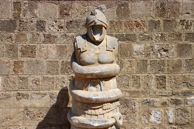 Old statue against wall