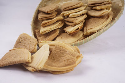 High angle view of bread on table against white background