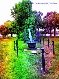 Statues in park against sky