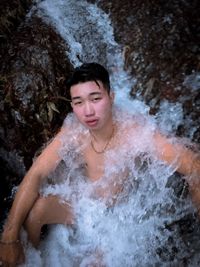 Portrait of teenage boy in water