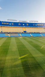 Scenic view of soccer field against clear sky