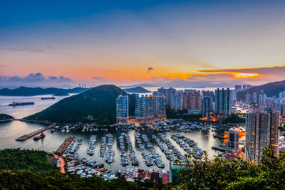 High angle view of illuminated buildings against sky during sunset