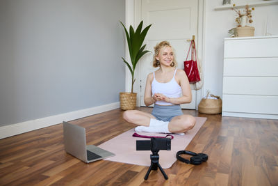 Portrait of woman sitting on sofa at home