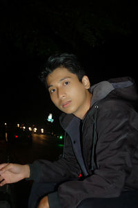 Portrait of a young man sitting outdoors