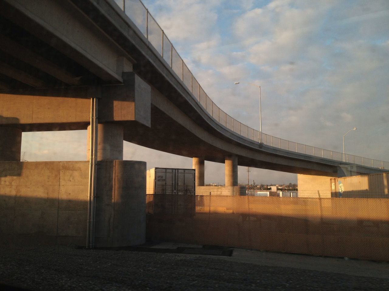 architecture, built structure, sky, building exterior, cloud - sky, bridge - man made structure, connection, low angle view, cloudy, city, building, cloud, railing, bridge, no people, dusk, transportation, outdoors, engineering, sunset