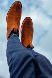 Low section of man wearing brown shoes