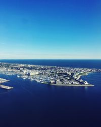 Aerial view of sea against clear blue sky