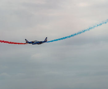 Low angle view of airplane flying against sky