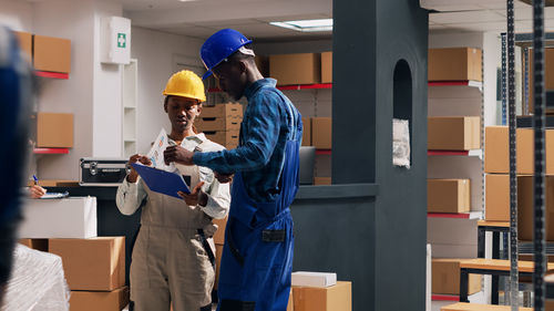 Rear view of man working in factory