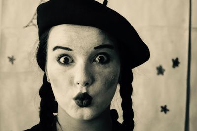 Close-up portrait of young woman at home