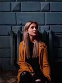 Portrait of young woman sitting outdoors