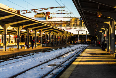 Train at railroad station platform against sky