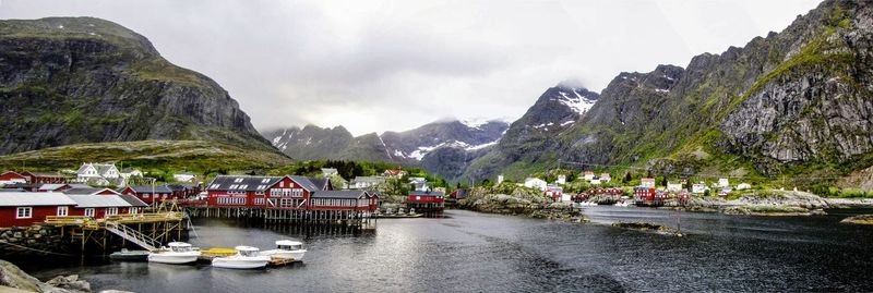 Scenic view of sea and mountains against sky