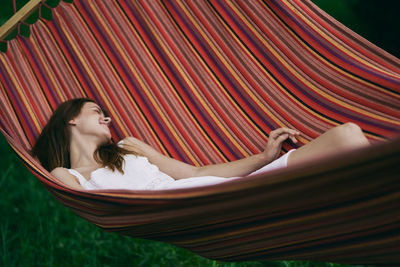 Woman lying on hammock