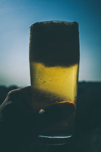Close-up of a man holding a beer glass
