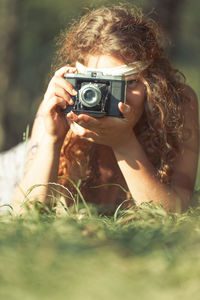 Portrait of woman photographing outdoors