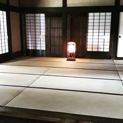 Illuminated lamp on floor in building