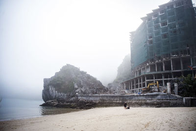 Panoramic view of sea and buildings against sky