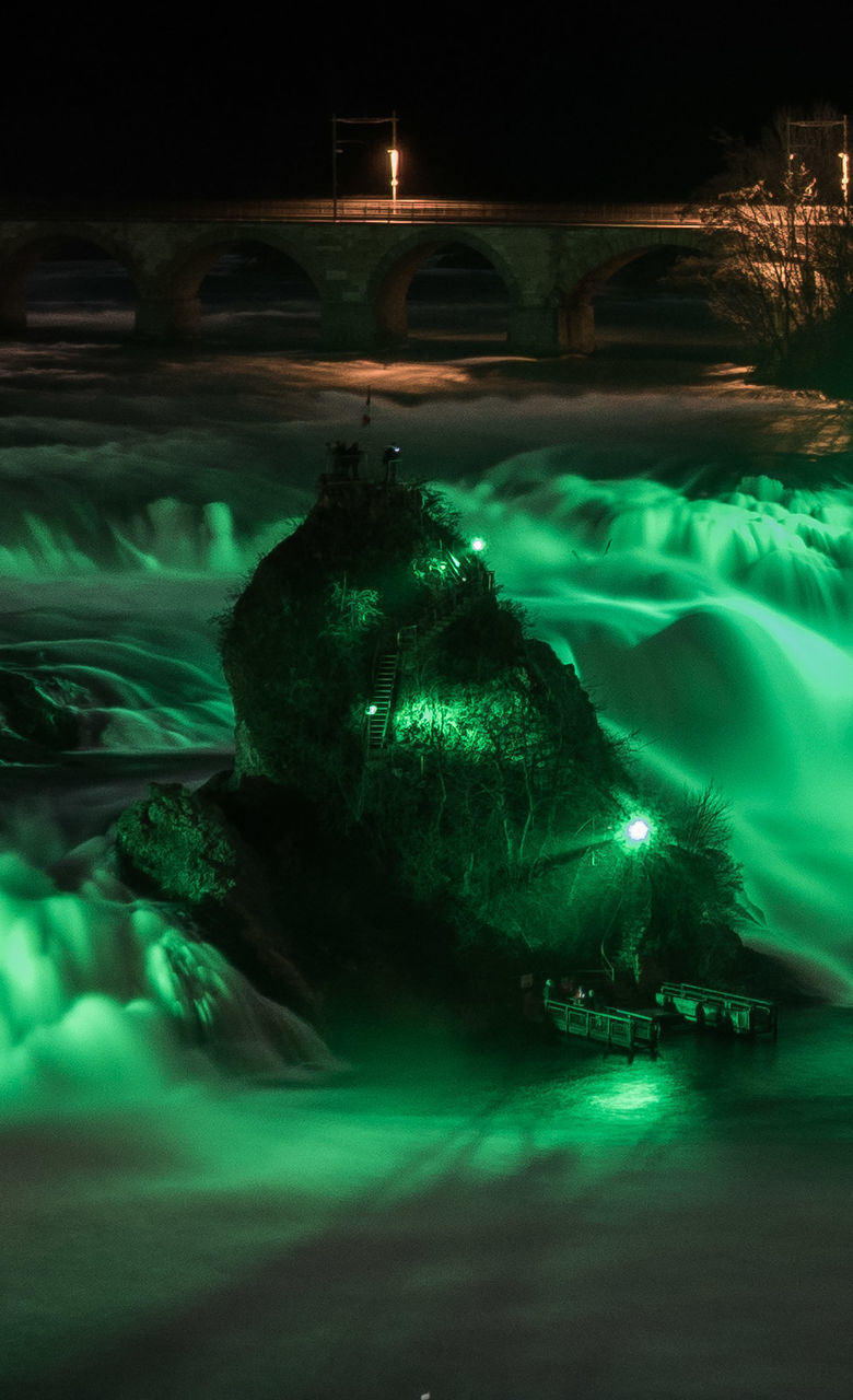 VIEW OF ILLUMINATED SWIMMING UNDERWATER