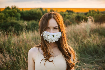 Statement masks, blinged out diy flower face mask design. girl in face mask decorated with flowers 