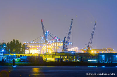 Illuminated commercial dock against sky at night