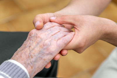 Cropped image of couple holding hands