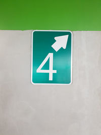 Close-up of arrow sign on wall