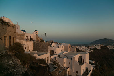 High angle view of buildings on mountain against clear sky during sunset