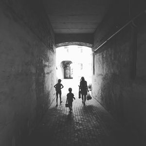 People walking in corridor of building