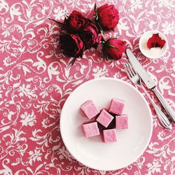 High angle view of pink roses in plate on table