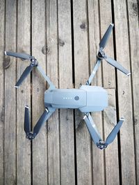 High angle view of quadcopter on wooden table