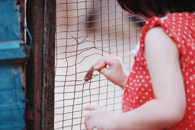 Close-up of hands holding girl standing