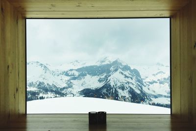 Scenic view of snow covered mountains against sky