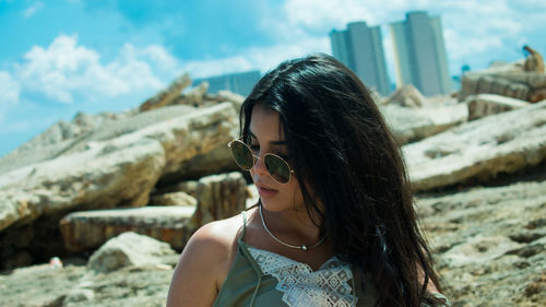 Portrait of young woman wearing sunglasses outdoors