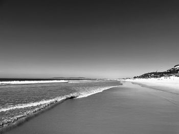 Scenic view of beach against clear sky