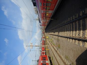 Panoramic view of railroad tracks in city against sky