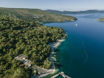 High angle view of sea and trees against sky