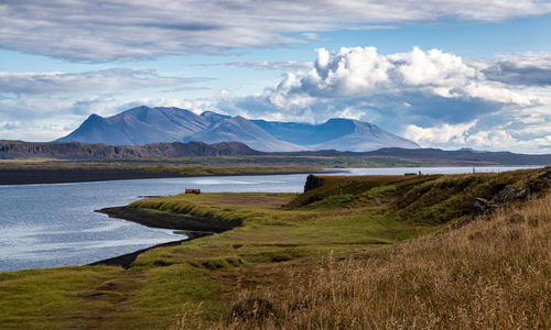 Scenic view of lake and mountains against sky