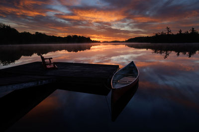 Boat in lake during sunset