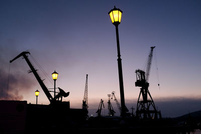 Low angle view of illuminated street light against sky