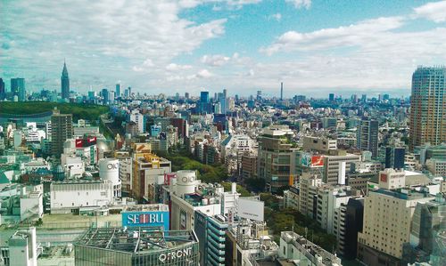 Skyscrapers against cloudy sky