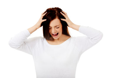 Young woman standing against white background