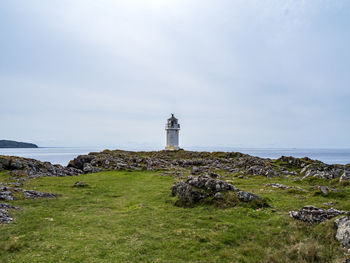 View of remote rubh an eun lighthouse at glencallum bay on the isle of bute, scotland