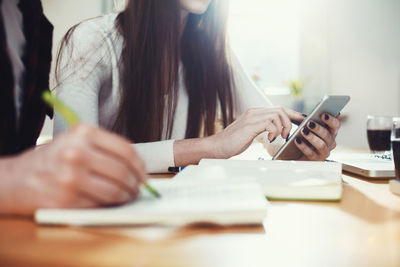Close-up of woman working on table